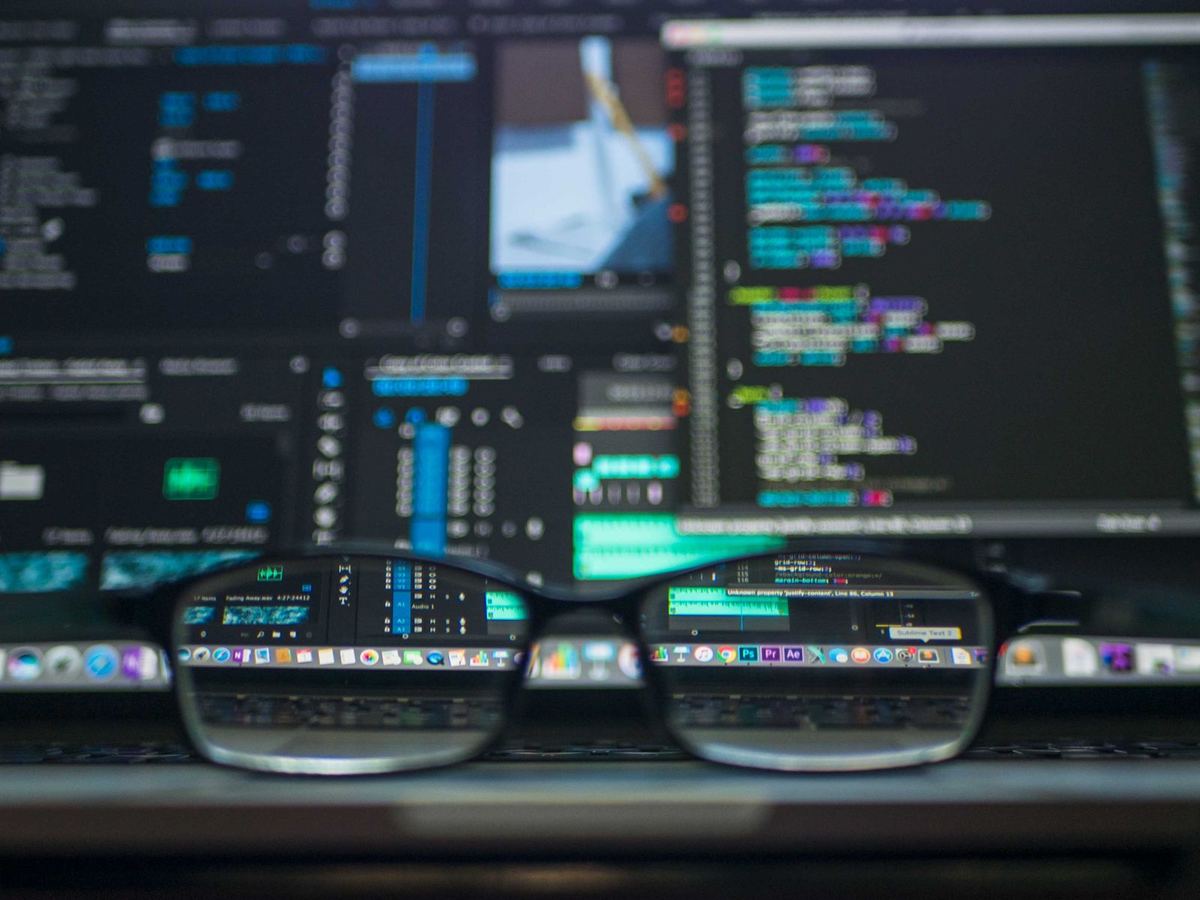 Glasses reflecting lines of code