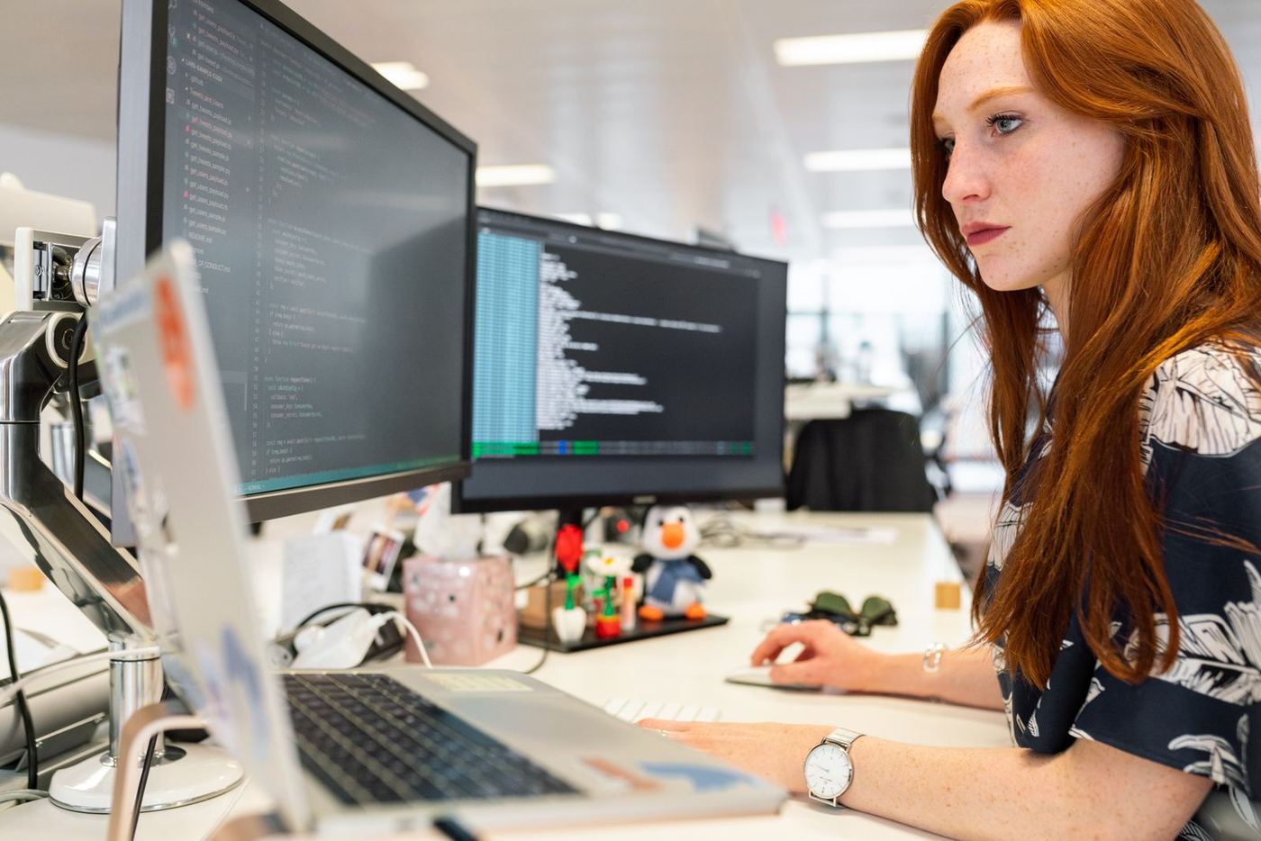 Developer working across multiple monitors
