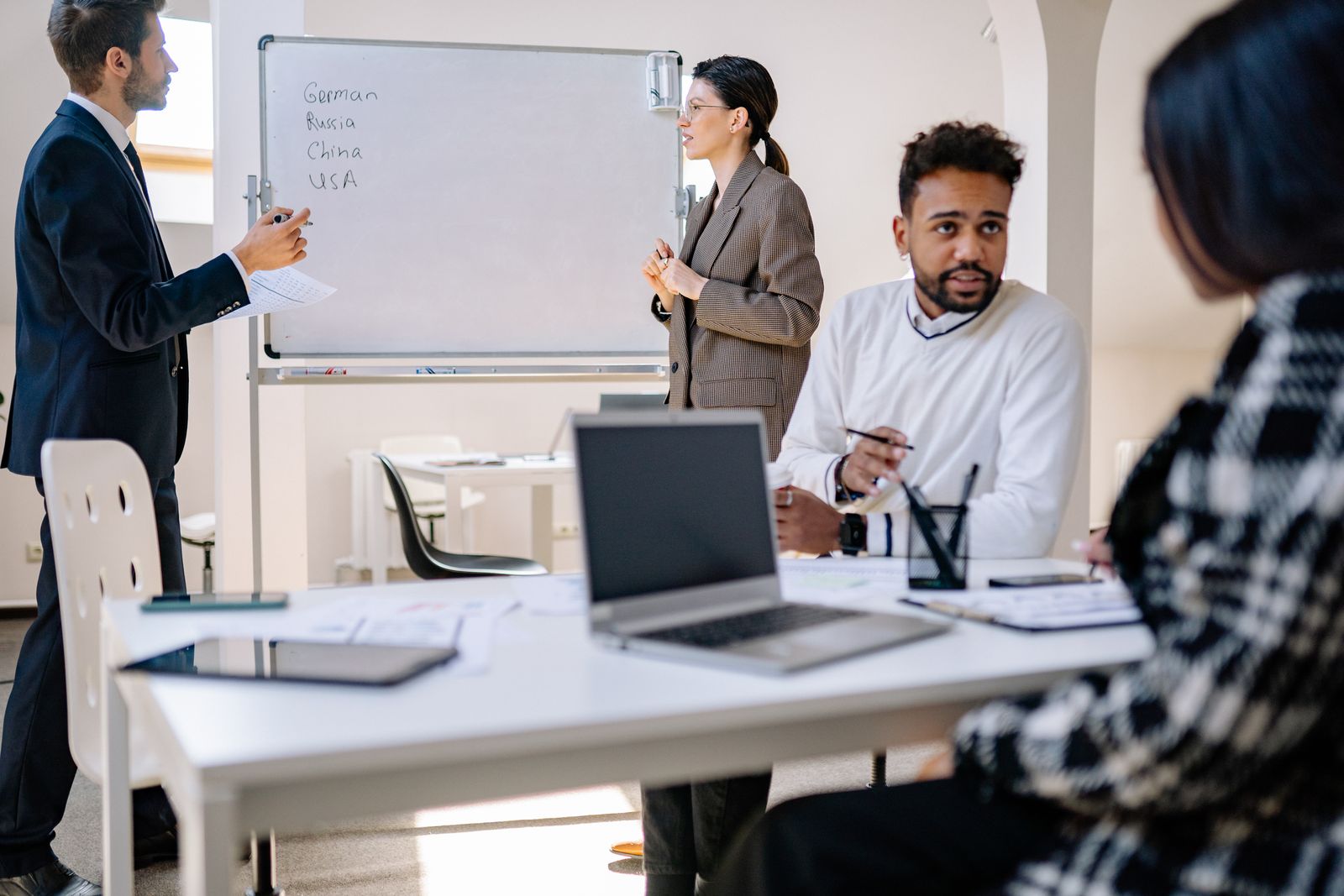Professionals in a collaborative meeting reviewing work together